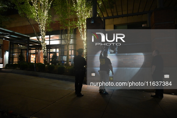 New York City Police Department crime scene investigators swab for evidence outside the One Carnegie Hill luxury rental apartment complex lo...