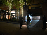 New York City Police Department crime scene investigators swab for evidence outside the One Carnegie Hill luxury rental apartment complex lo...