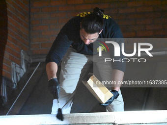 New York City Police Department crime scene investigators swab for evidence outside the One Carnegie Hill luxury rental apartment complex lo...