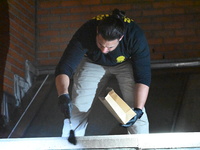 New York City Police Department crime scene investigators swab for evidence outside the One Carnegie Hill luxury rental apartment complex lo...