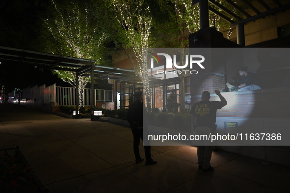 New York City Police Department crime scene investigators swab for evidence outside the One Carnegie Hill luxury rental apartment complex lo...