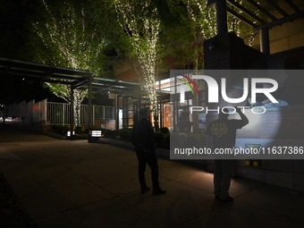 New York City Police Department crime scene investigators swab for evidence outside the One Carnegie Hill luxury rental apartment complex lo...