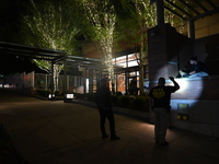 New York City Police Department crime scene investigators swab for evidence outside the One Carnegie Hill luxury rental apartment complex lo...