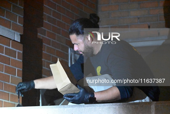 New York City Police Department crime scene investigators swab for evidence outside the One Carnegie Hill luxury rental apartment complex lo...