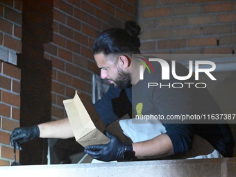 New York City Police Department crime scene investigators swab for evidence outside the One Carnegie Hill luxury rental apartment complex lo...