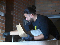 New York City Police Department crime scene investigators swab for evidence outside the One Carnegie Hill luxury rental apartment complex lo...