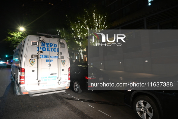 New York City Police Department crime scene investigators swab for evidence outside the One Carnegie Hill luxury rental apartment complex lo...