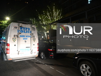 New York City Police Department crime scene investigators swab for evidence outside the One Carnegie Hill luxury rental apartment complex lo...