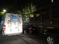 New York City Police Department crime scene investigators swab for evidence outside the One Carnegie Hill luxury rental apartment complex lo...