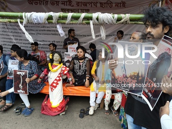 Doctors and citizens hold placards and shout slogans during a protest against the rape and murder of a PGT woman doctor at the government-ru...