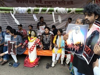 Doctors and citizens hold placards and shout slogans during a protest against the rape and murder of a PGT woman doctor at the government-ru...