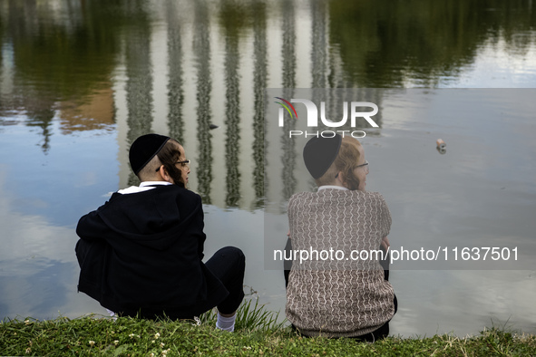 Ultra-Orthodox Jewish pilgrims pray on the bank of a lake near the tomb of Rabbi Nachman while celebrating Rosh Hashanah, the Jewish New Yea...