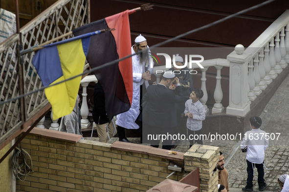 Ultra-Orthodox Jewish pilgrims talk on the street near the tomb of Rabbi Nachman while celebrating Rosh Hashanah, the Jewish New Year, amid...