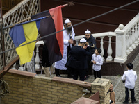 Ultra-Orthodox Jewish pilgrims talk on the street near the tomb of Rabbi Nachman while celebrating Rosh Hashanah, the Jewish New Year, amid...