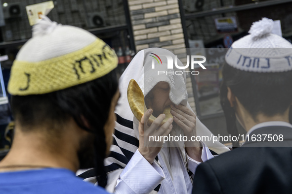 An Ultra-Orthodox Jewish pilgrim blows a shofar on the street near the tomb of Rabbi Nachman while celebrating Rosh Hashanah, the Jewish New...