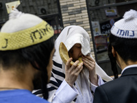 An Ultra-Orthodox Jewish pilgrim blows a shofar on the street near the tomb of Rabbi Nachman while celebrating Rosh Hashanah, the Jewish New...