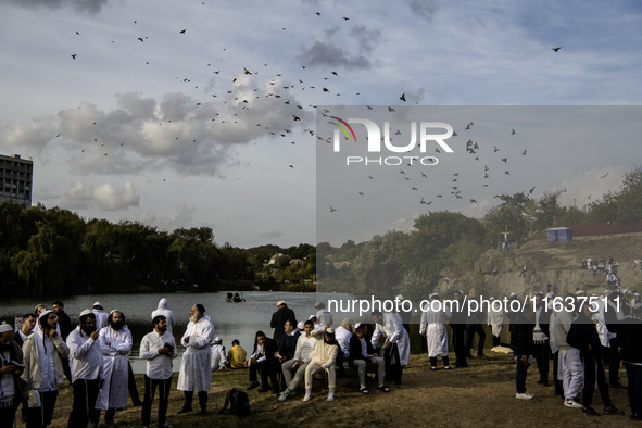 Ultra-Orthodox Jewish pilgrims pray on the bank of a lake near the tomb of Rabbi Nachman while celebrating Rosh Hashanah, the Jewish New Yea...