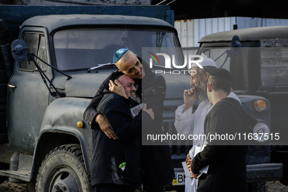 Ultra-Orthodox Jewish pilgrims talk on the street near the tomb of Rabbi Nachman while celebrating Rosh Hashanah, the Jewish New Year, amid...