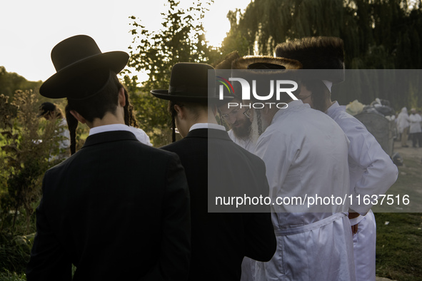 Ultra-Orthodox Jewish pilgrims pray on the bank of a lake near the tomb of Rabbi Nachman while celebrating Rosh Hashanah, the Jewish New Yea...