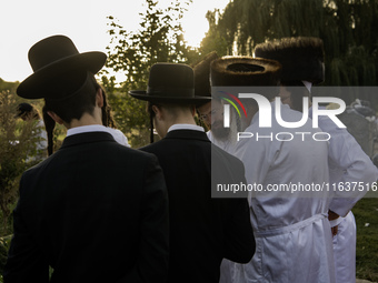 Ultra-Orthodox Jewish pilgrims pray on the bank of a lake near the tomb of Rabbi Nachman while celebrating Rosh Hashanah, the Jewish New Yea...