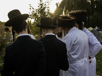 Ultra-Orthodox Jewish pilgrims pray on the bank of a lake near the tomb of Rabbi Nachman while celebrating Rosh Hashanah, the Jewish New Yea...