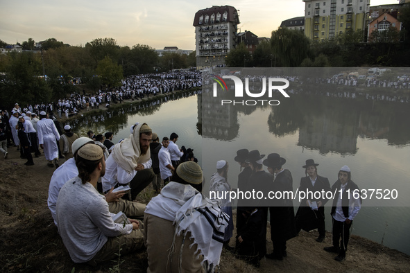 Ultra-Orthodox Jewish pilgrims pray on the bank of a lake near the tomb of Rabbi Nachman while celebrating Rosh Hashanah, the Jewish New Yea...