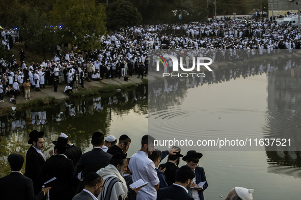 Ultra-Orthodox Jewish pilgrims pray on the bank of a lake near the tomb of Rabbi Nachman while celebrating Rosh Hashanah, the Jewish New Yea...