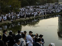 Ultra-Orthodox Jewish pilgrims pray on the bank of a lake near the tomb of Rabbi Nachman while celebrating Rosh Hashanah, the Jewish New Yea...