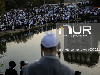 Ultra-Orthodox Jewish pilgrims pray on the bank of a lake near the tomb of Rabbi Nachman while celebrating Rosh Hashanah, the Jewish New Yea...