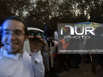 Ultra-Orthodox Jewish pilgrims are on the street near the tomb of Rabbi Nachman while celebrating Rosh Hashanah, the Jewish New Year, amid t...