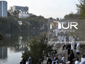 Ultra-Orthodox Jewish pilgrims pray on the bank of a lake near the tomb of Rabbi Nachman while celebrating Rosh Hashanah, the Jewish New Yea...