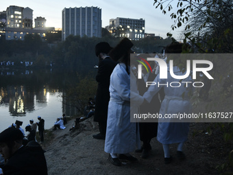 Ultra-Orthodox Jewish pilgrims dance on the bank of a lake near the tomb of Rabbi Nachman while celebrating Rosh Hashanah, the Jewish New Ye...