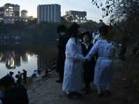 Ultra-Orthodox Jewish pilgrims dance on the bank of a lake near the tomb of Rabbi Nachman while celebrating Rosh Hashanah, the Jewish New Ye...