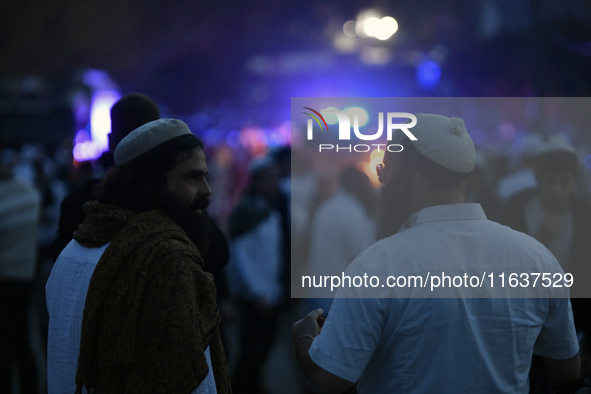 Ultra-Orthodox Jewish pilgrims are on the street near the tomb of Rabbi Nachman while celebrating Rosh Hashanah, the Jewish New Year, amid t...