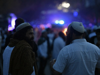 Ultra-Orthodox Jewish pilgrims are on the street near the tomb of Rabbi Nachman while celebrating Rosh Hashanah, the Jewish New Year, amid t...