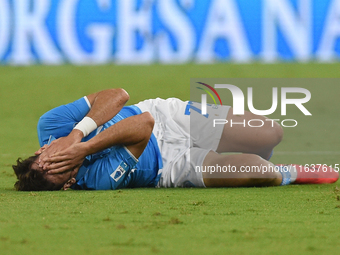 Khvicha Kvaratskhelia of SSC Napoli lies on the pitch after suffering an injury during the Serie A match between SSC Napoli and Como at Stad...