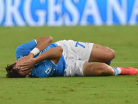 Khvicha Kvaratskhelia of SSC Napoli lies on the pitch after suffering an injury during the Serie A match between SSC Napoli and Como at Stad...