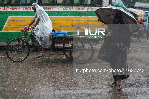 Residents of the city suffer from continuous rain in Dhaka, Bangladesh, on October 5, 2024. 