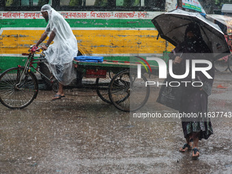 Residents of the city suffer from continuous rain in Dhaka, Bangladesh, on October 5, 2024. (