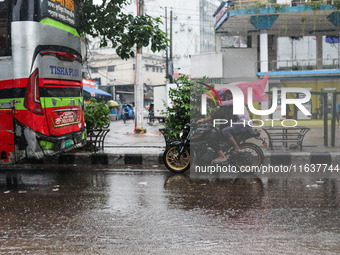 Residents of the city suffer from continuous rain in Dhaka, Bangladesh, on October 5, 2024. (