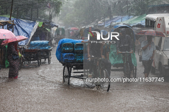 Residents of the city suffer from continuous rain in Dhaka, Bangladesh, on October 5, 2024. 