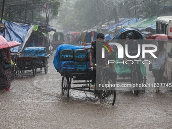 Residents of the city suffer from continuous rain in Dhaka, Bangladesh, on October 5, 2024. (