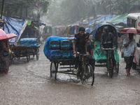 Residents of the city suffer from continuous rain in Dhaka, Bangladesh, on October 5, 2024. (