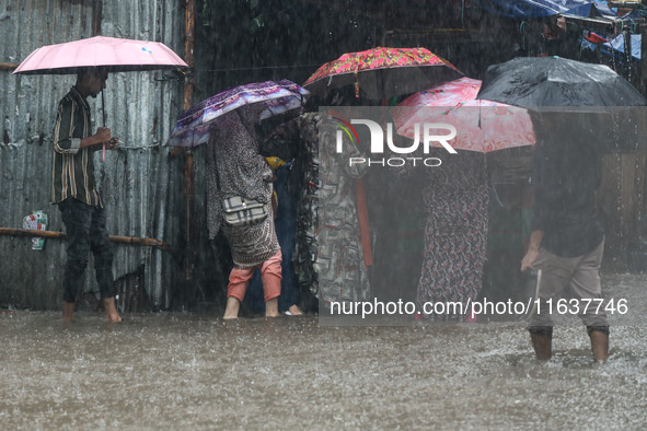 Residents of the city suffer from continuous rain in Dhaka, Bangladesh, on October 5, 2024. 