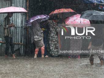 Residents of the city suffer from continuous rain in Dhaka, Bangladesh, on October 5, 2024. (