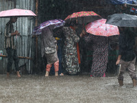 Residents of the city suffer from continuous rain in Dhaka, Bangladesh, on October 5, 2024. (