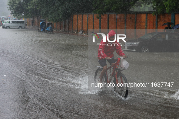 Residents of the city suffer from continuous rain in Dhaka, Bangladesh, on October 5, 2024. 