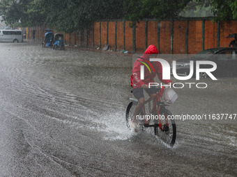 Residents of the city suffer from continuous rain in Dhaka, Bangladesh, on October 5, 2024. (