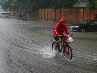 Residents of the city suffer from continuous rain in Dhaka, Bangladesh, on October 5, 2024. (