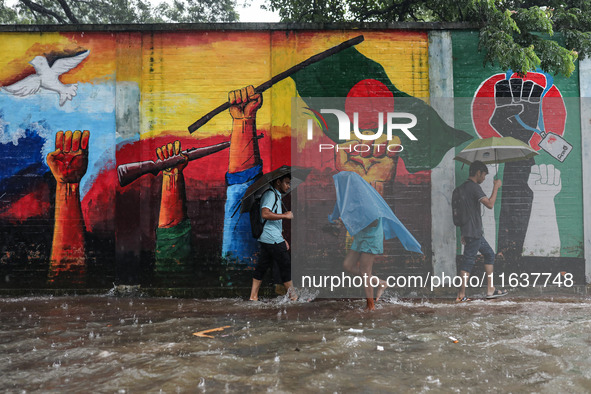 Residents of the city suffer from continuous rain in Dhaka, Bangladesh, on October 5, 2024. 